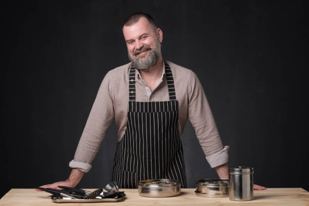 istock Bearded male chef showing different spices he uses. 1147503559