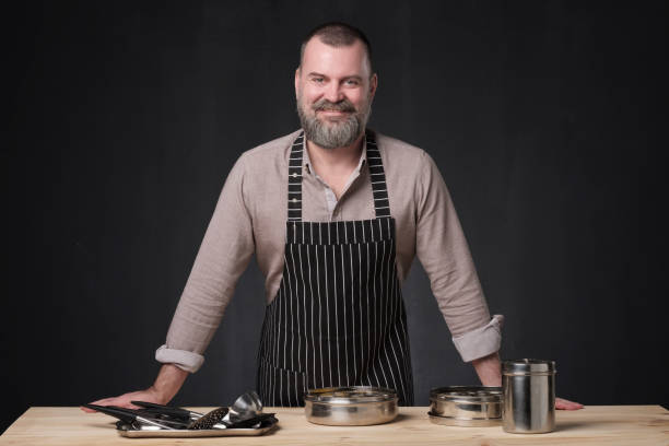istock Bearded male chef showing different spices he uses. 1147503572