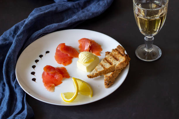 istock Trout, butter, bread and white wine. Dark background 1147503825