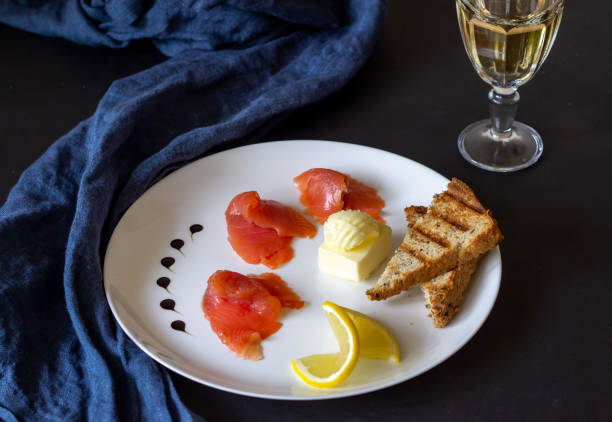 istock Trout, butter, bread and white wine. Dark background 1147503836