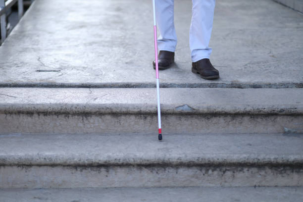 istock Blind and bearded man with a walking stick on the street 1147505221