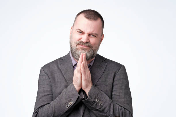istock Hopeful man join hands in prayer asking for help 1147505453