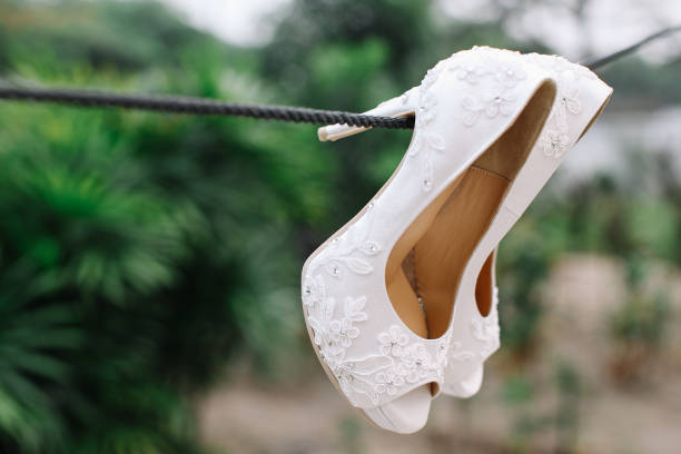 istock White high heels hanging on a rope 1147505640