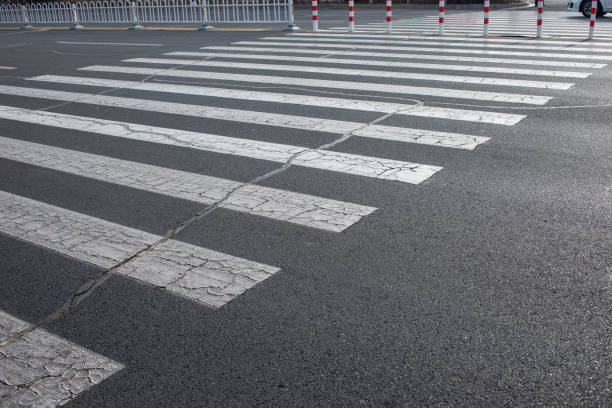 istock Dry and cracked zebra crossing and asphalt pavement 1147506783