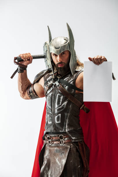 istock Man in cosplaying Thor isolated on white studio background 1147508560