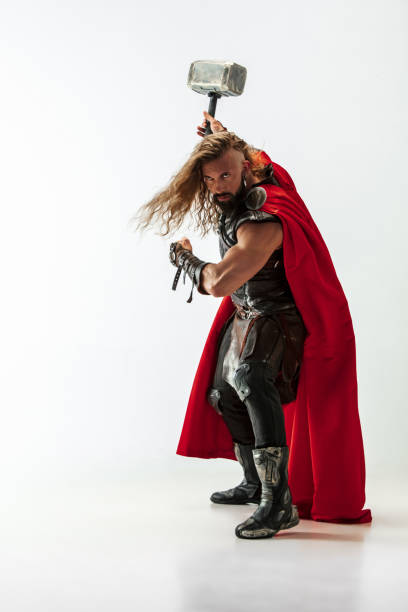 istock Man in cosplaying Thor isolated on white studio background 1147508576