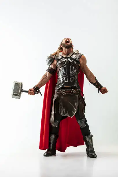 Photo of Man in cosplaying Thor isolated on white studio background