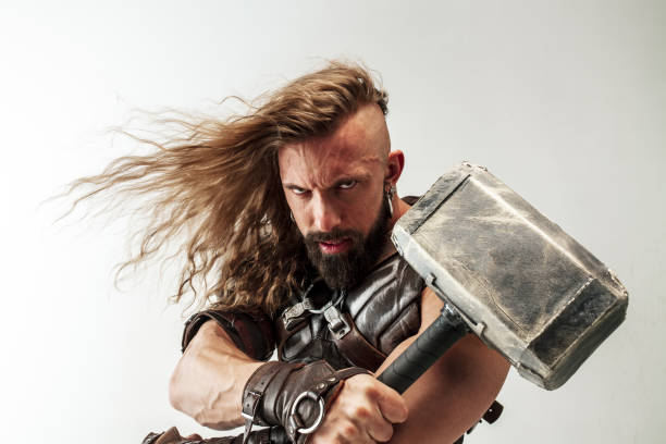 istock Man in cosplaying Thor isolated on white studio background 1147508672