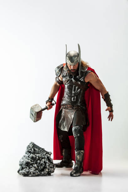 istock Man in cosplaying Thor isolated on white studio background 1147508704