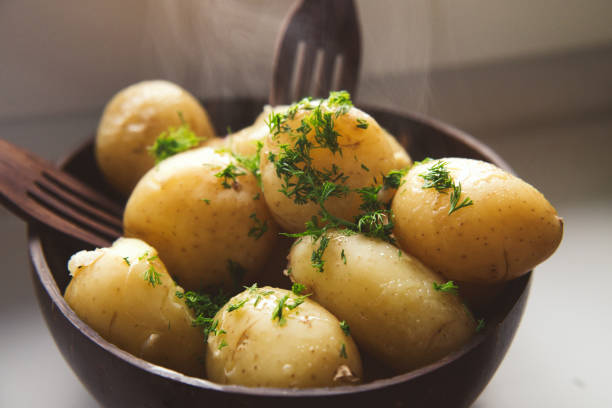 Boiled young potatoes with butter and dill served in the eco coconut bowl Delicious spring dinner boiled potatoes stock pictures, royalty-free photos & images