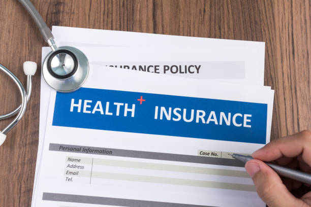 istock Health insurance form in man hand 1147509040