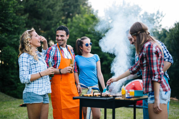 istock Happy students having barbecue on summer day 1147510678