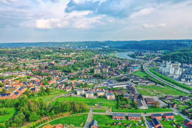 vista sulla città di huy in belgio e sul fiume mosa fino alla lontana centrale nucleare di tihange - tihange foto e immagini stock