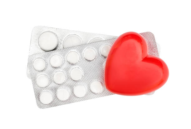istock Red heart with pills in blisters on white. Top view. 1147513313