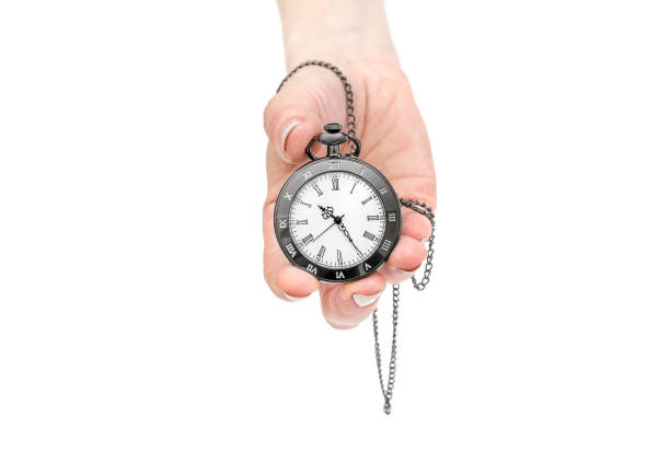 istock Woman's hand holding pocket watch. Isolated on white. 1147513428
