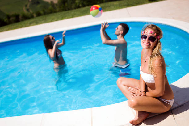 istock Friends playing ball games in pool 1147514602