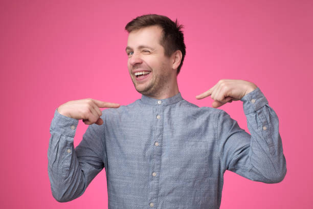istock Man looking confident with smile on face pointing with fingers at himself 1147514769