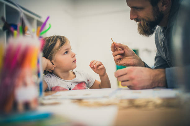 istock Teacher helping girl in classroom 1147517014