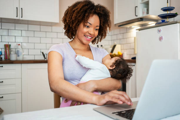 istock Mother and daughter using laptop at home 1147518140