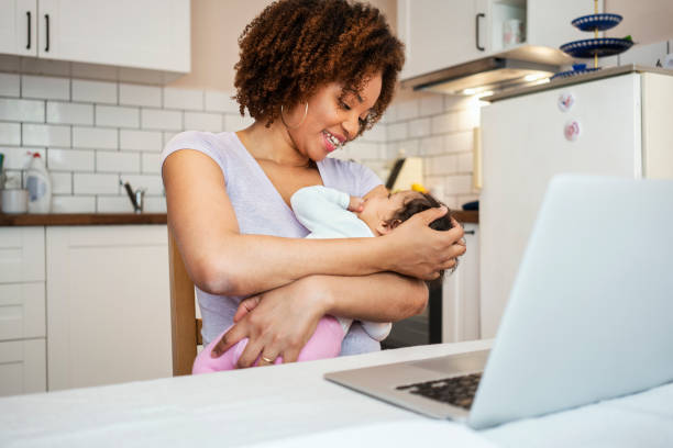 istock Mother and daughter using laptop at home 1147518142