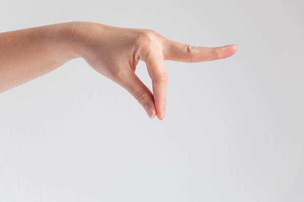 A hand of woman posturing thumb and forefinger touch together and other finger stretch forward on white background. A hand showing thumb and forefinger touch together and other finger forward; posture like holding at end of object; or catching something dirty or holding with disgusting; or posture let out ingredient powder of chef. pollex stock pictures, royalty-free photos & images