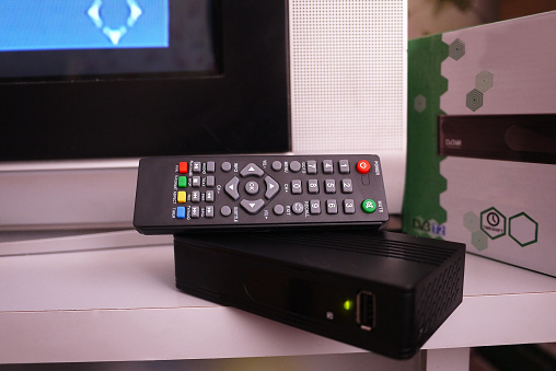 Set-top box for receiving video and TV signal. Remote control. Details and close-up.