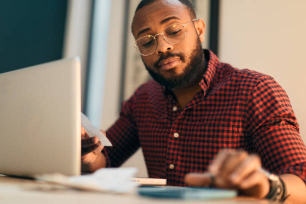 istock Young millennial using technology for his investment and on line banking. 1147519511