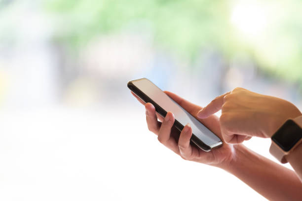 istock Close up girl pointing finger on screen smart phone on blur background text mobile, mock up glitter street, content lifestyle 1147519785