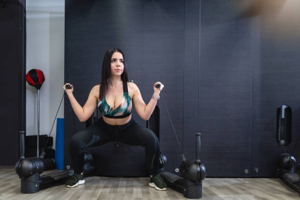 istock Handsome black haired girl doing weighted workout 1147520825