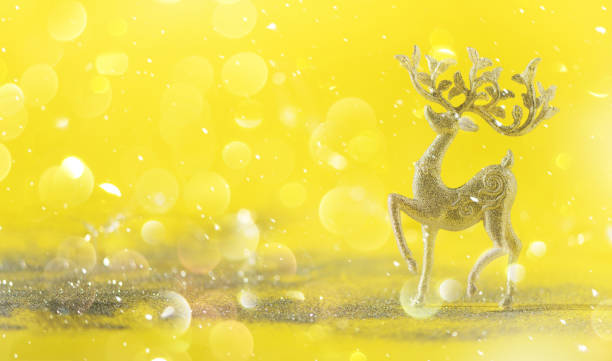 istock Silver glitter Christmas deer on yellow background with lights bokeh, copy space. Greeting card for new year party. Festive holiday concept. Banner 1147521124
