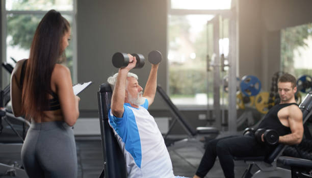 istock Female personal trainer observing clients doing exercises. 1147521374