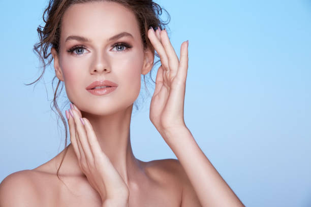 istock Gorgeous woman at blue studio background 1147523250