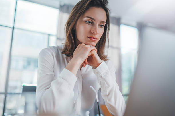 istock Positive entrepreneur female using mobile laptop for looking a new business solution during work process at office.Blurred background. 1147525366