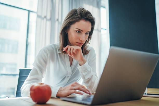 istock Young entrepreneur female using mobile laptop for looking a new business solution during work process at office.Blurred background. 1147525403