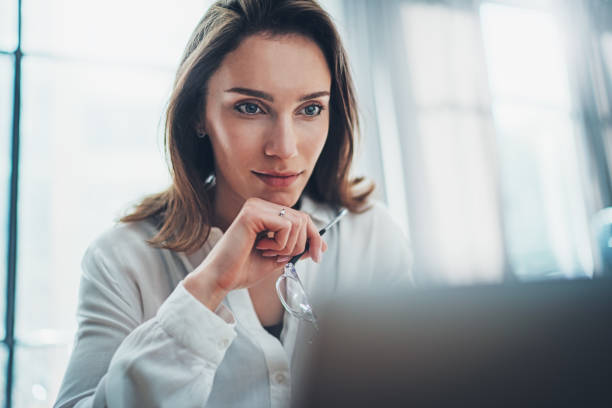 istock Confident business female using mobile laptop for looking a new business solution during work process at office.Blurred background. 1147525502