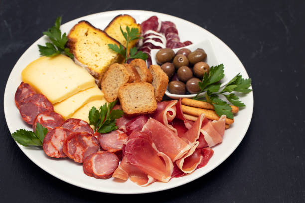 istock cheese with prosciutto and smoked sausages on white dish 1147526348