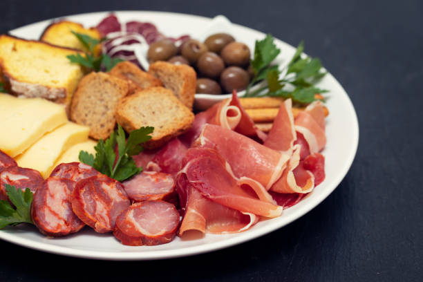 istock cheese with prosciutto and smoked sausages on white dish 1147526386