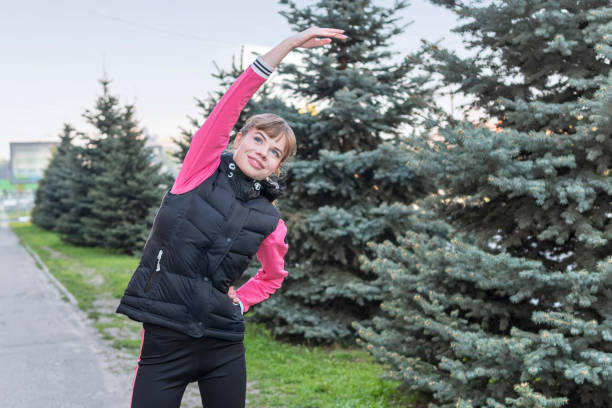 istock athletic woman leans to the side 1147526443