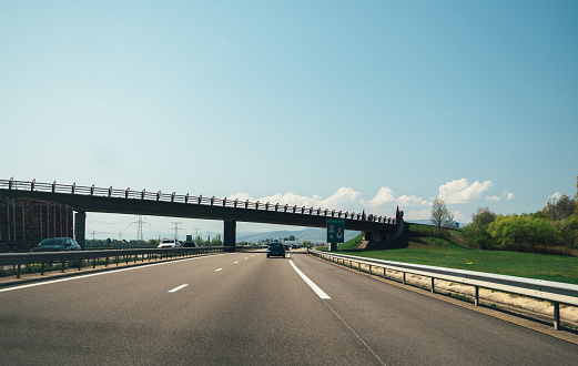 France - Apr 19, 2019: Driver point of view POV at French highway with cars driving fast under the bridge
