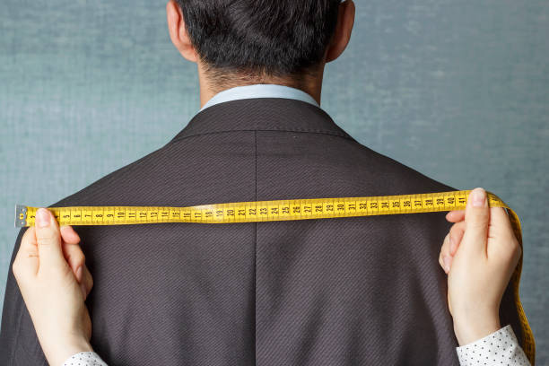 istock The tailor measures the suit with a measuring tape close-up 1147528570