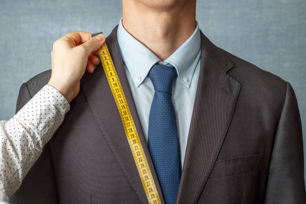 istock The tailor measures the suit with a measuring tape close-up 1147528608