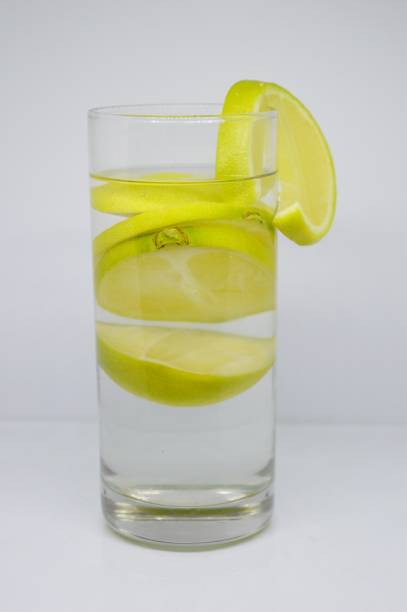 istock Fresh lemon water in the glass with white background. 1147529080
