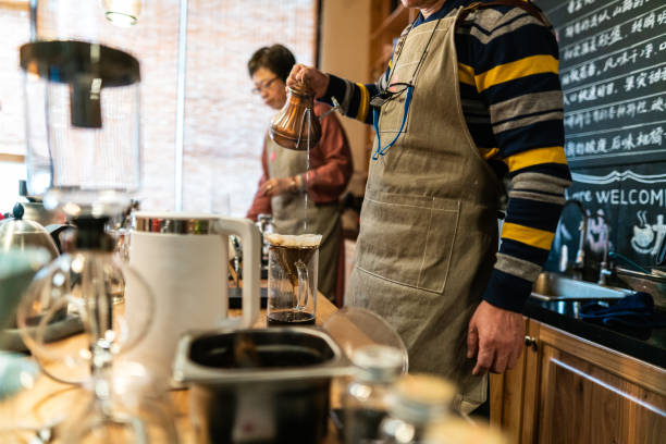 istock Couple making pour-over coffee in coffee shop 1147531799