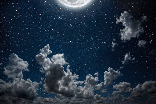 istock backgrounds night sky with stars and moon and clouds. 1147531989