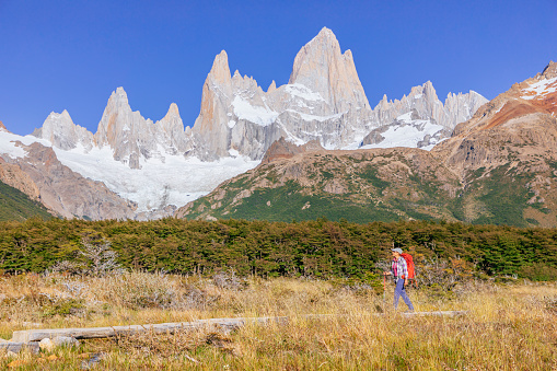 A woman is hiking the trail to Laguna de los Tres with a view to Mount Fitz roy in Los Glaciares National Park