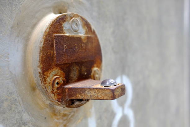istock Rusty Metal Cover on Concrete Wall in Long Nose Human Face. 1147532634