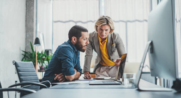 istock Business team making conversation at sunny meeting room. 1147533447