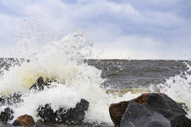 istock the waves beat against the rocks on the sea shore creating splashes 1147534130