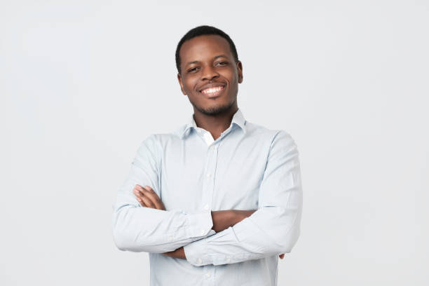 istock Laughing handsome young african man in shirt smiling confident 1147534387