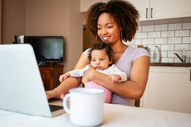 istock Mother and daughter using laptop at home 1147534671